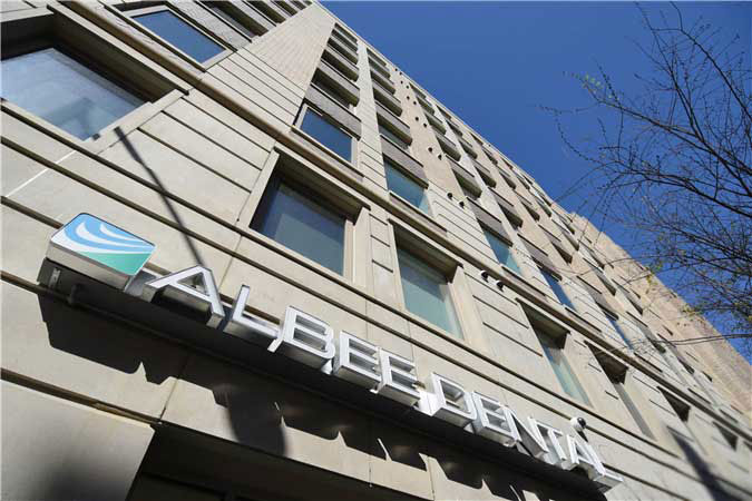 The image shows a building with multiple windows and a sign that reads  ABCDESIGN,  suggesting it is the name of the establishment.